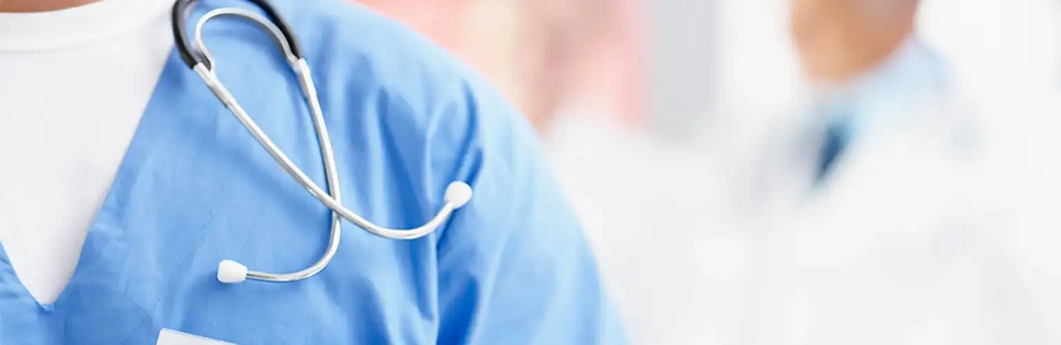 Stethoscope over blue medical uniform